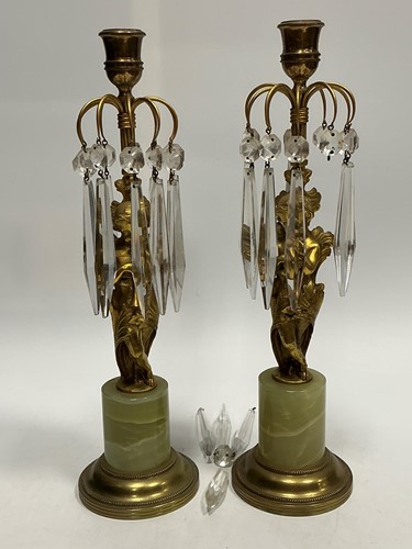 Lot 12 - A pair of gilt metal on onyx candle lustres,...