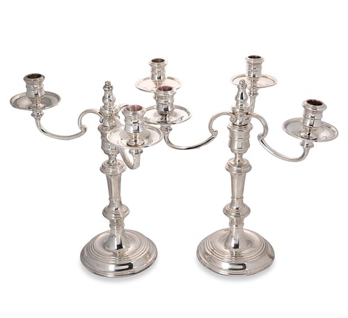 Lot 430 - An Elizabeth II silver pair of three-branch candelabra