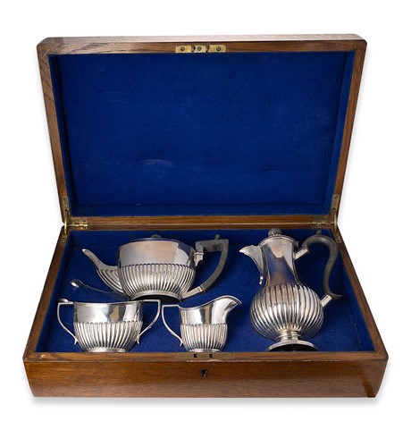 Lot 404 - An oak cased George V silver four-piece tea set