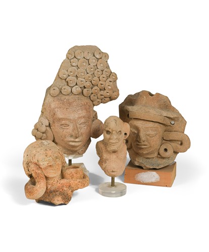 Lot 495 - A Pre-Columbian style stone head of a Mayan solar deity, possibly Classic period