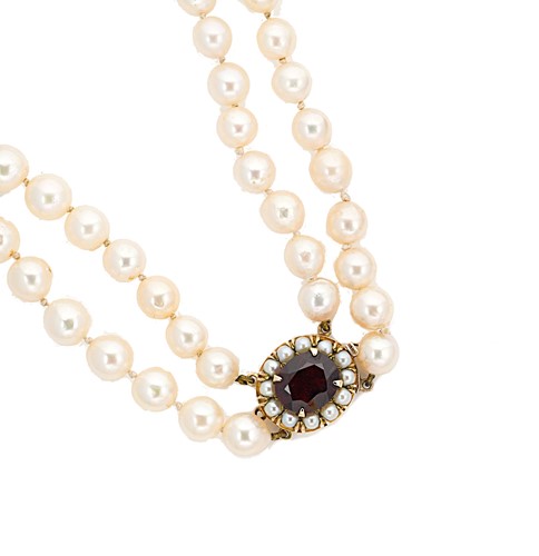 Lot 60 - A double row cultured pearl necklace with a garnet clasp