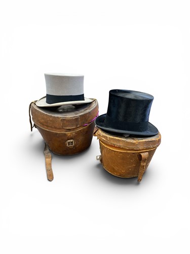 Lot 111 - Two Lock & Co top hats, in grey and black,...