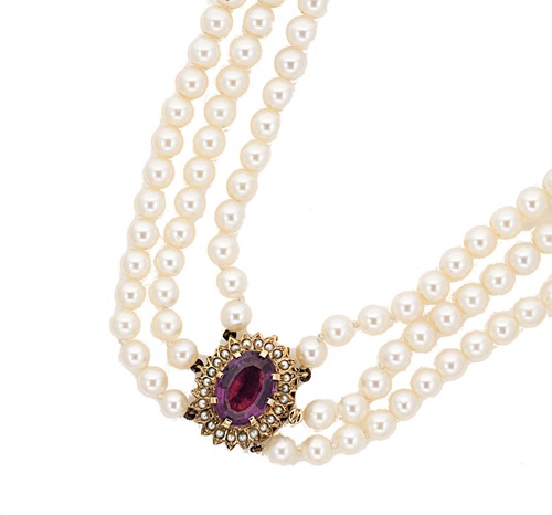 Lot 44 - A triple row cultured pearl necklace with an amethyst clasp