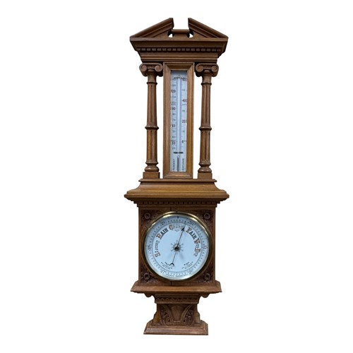 Lot 760 - An early 20th century carved oak aneroid...