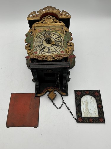 Lot 204 - A Dutch painted wall clock, the face painted...