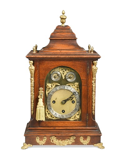 Lot 444 - An Edwardian oak and gilt metal mounted chiming backet clock