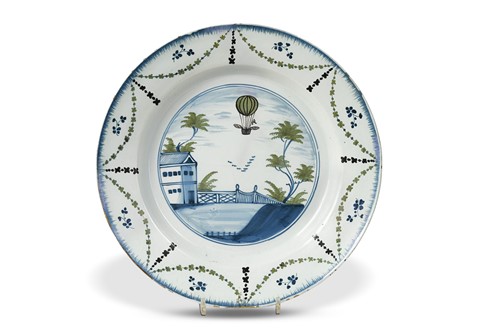 Lot 390 - A Delft polychrome charger, Lambeth, circa 1785