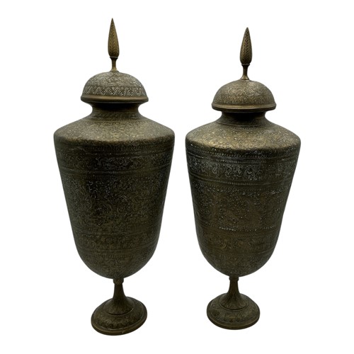 Lot 173 - A pair of Persian brass vases and covers