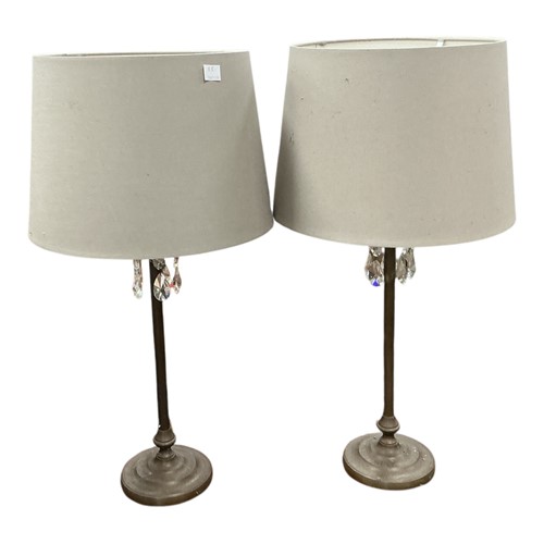 Lot 769 - A pair of brass lamps, the tops set with glass...