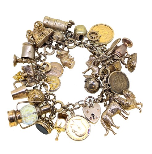 Lot 50 - A late 20th century 9ct gold charm bracelet,...