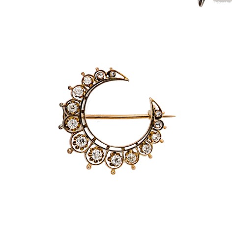 Lot 110 - A diamond set crescent brooch
