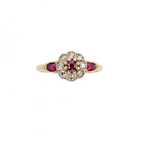 Lot 142 - An early 20th century ruby and diamond daisy style cluster ring