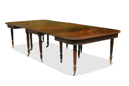 Lot 560 - A late George III mahogany extending D-end dining table, stamped Gillows