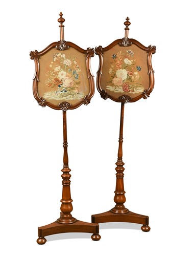 Lot 673 - A pair of Victorian mahogany pole screens