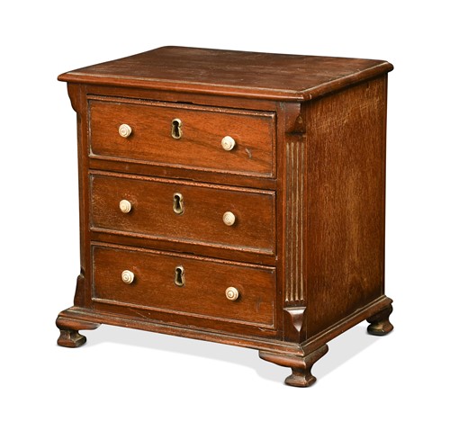 Lot 661 - A George III mahogany miniature chest of drawers