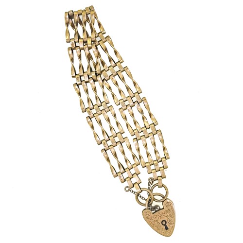 Lot 62 - A 9ct gold gate style bracelet with a heart...