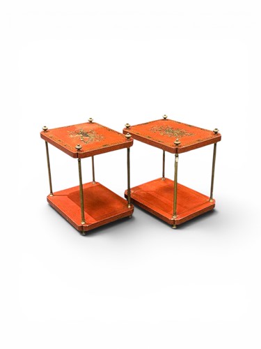 Lot 579 - A pair of red lacquered two tier tables with...