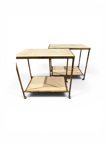 Lot 580 - A pair of low metal two tier tables with...