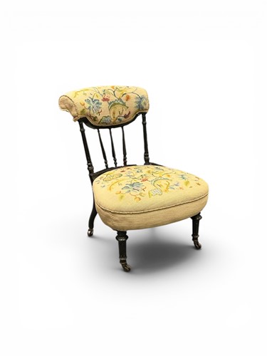 Lot 600 - A late 19th century ebonised low fireside...