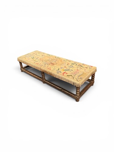 Lot 574 - A low bobbin turned oak fireside stool with...