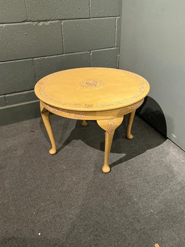 Lot 595 - A low cream painted coffee table with pad feet...