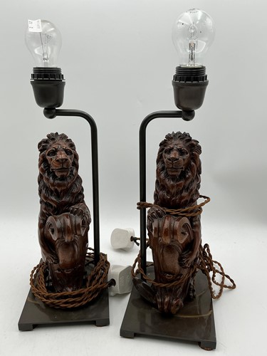 Lot 178 - A pair of carved wooden lions a passant, now...