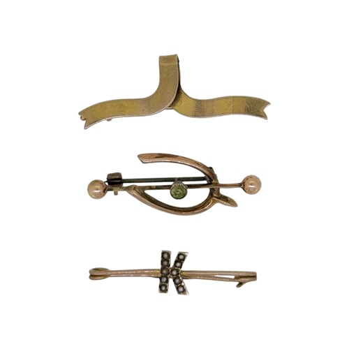 Lot 21 - A trio of brooches, to include, a peridot...