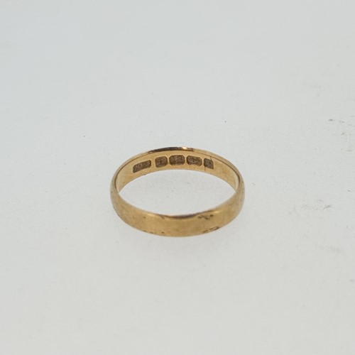 Lot 2 - A wedding band, size K, hallmarked 18ct gold,...