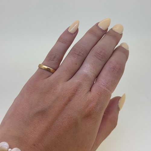 Lot 2 - A wedding band, size K, hallmarked 18ct gold,...