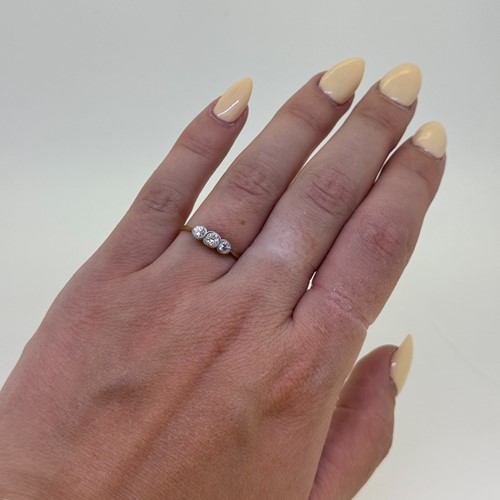 Lot 4 - An early 20th century three stone diamond ring,...