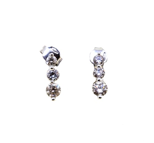 Lot 29 - A pair of three stone diamond earrings, length...