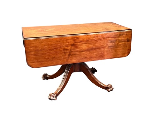 Lot 669 - A mahogany drop leaf dining table with four...