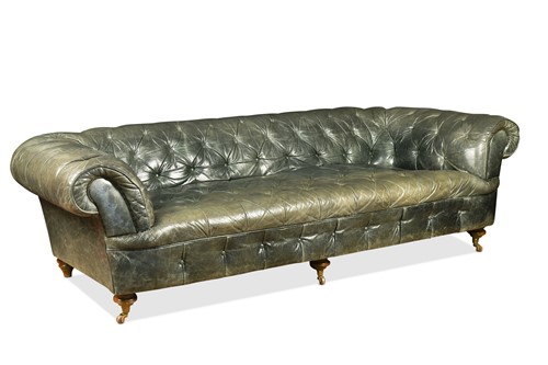 Lot 695 - A green leather three seat Chesterfield sofa, 20th century