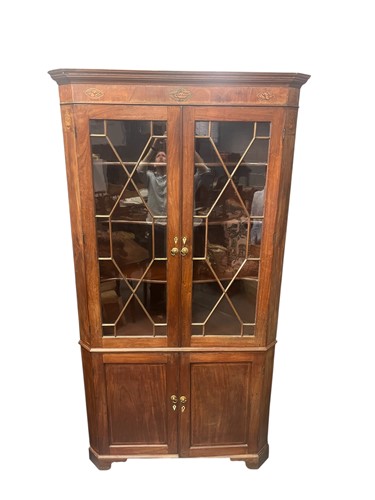 Lot 708 - A George III mahogany corner cupboard