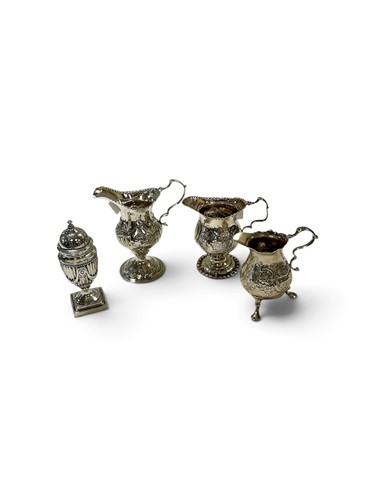 Lot 282 - A collection of three silver jugs and a sugar sifter