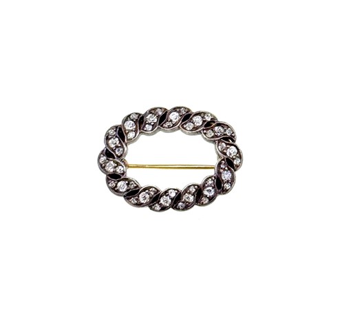 Lot 53 - An oval shaped brooch set with old brilliant...