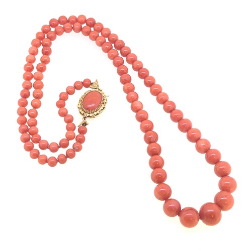 Lot 84 - A graduated coral bead necklace, beads from...