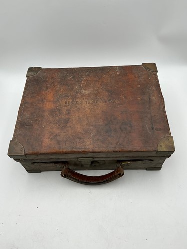Lot 135 - Early 20th century brass bound leather...