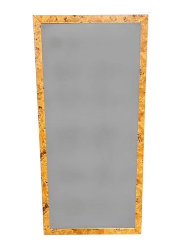 Lot 699 - A modern burrwood veneered wall mirror, of...