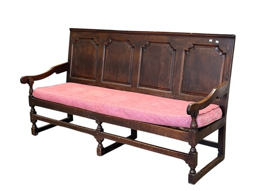 Lot 672 - An oak panel backed settle, 18th century, the...