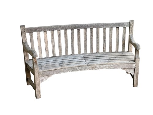 Lot 784 - A curved teak garden bench, slatted seat and...